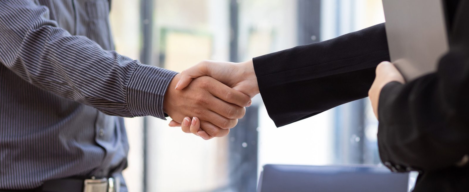 Handshake. Businessman shaking hands with coworker and agreeing business partnership.